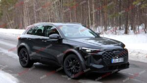 A black Audi Q5 being used as a Porsche Macan mule for winter testing