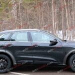 A black Audi Q5 being used as a Porsche Macan mule for winter testing