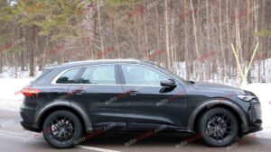 A black Audi Q5 being used as a Porsche Macan mule for winter testing