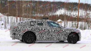 Spy shot of the 2027 Range Rover Velar side covered in camouflage.