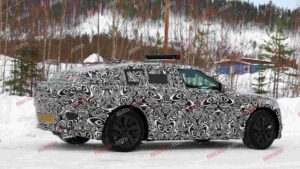 Spy shot of the 2027 Range Rover Velar side covered in camouflage.