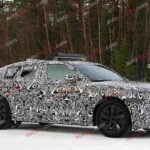 Spy shot of the 2027 Range Rover Velar side covered in camouflage.