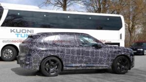 Side view of a a camouflaged BMW iX5 M70 prototype