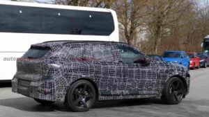 Side view of a a camouflaged BMW iX5 M70 prototype