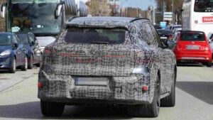 Rear view of a a camouflaged BMW iX5 M70 prototype
