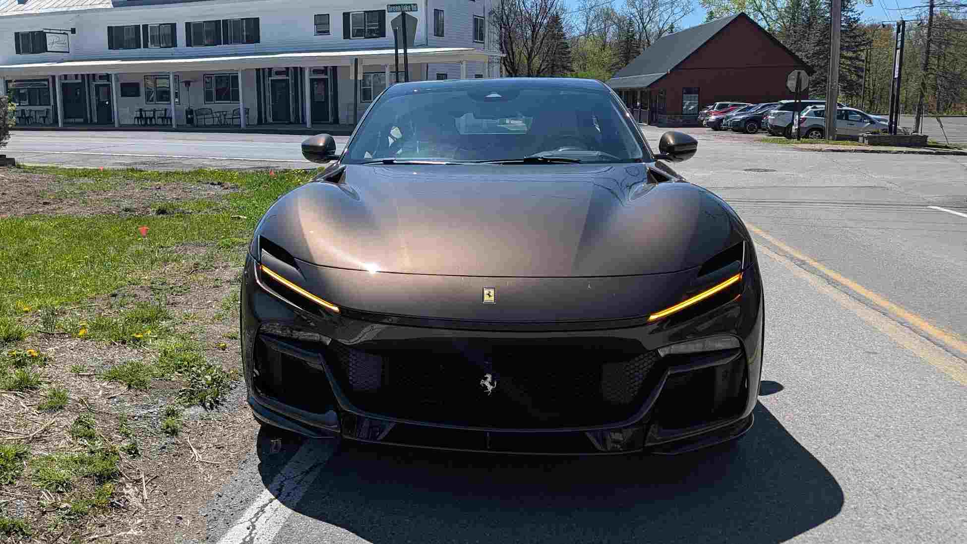 Front view of a a Ferrari Purosangue in town