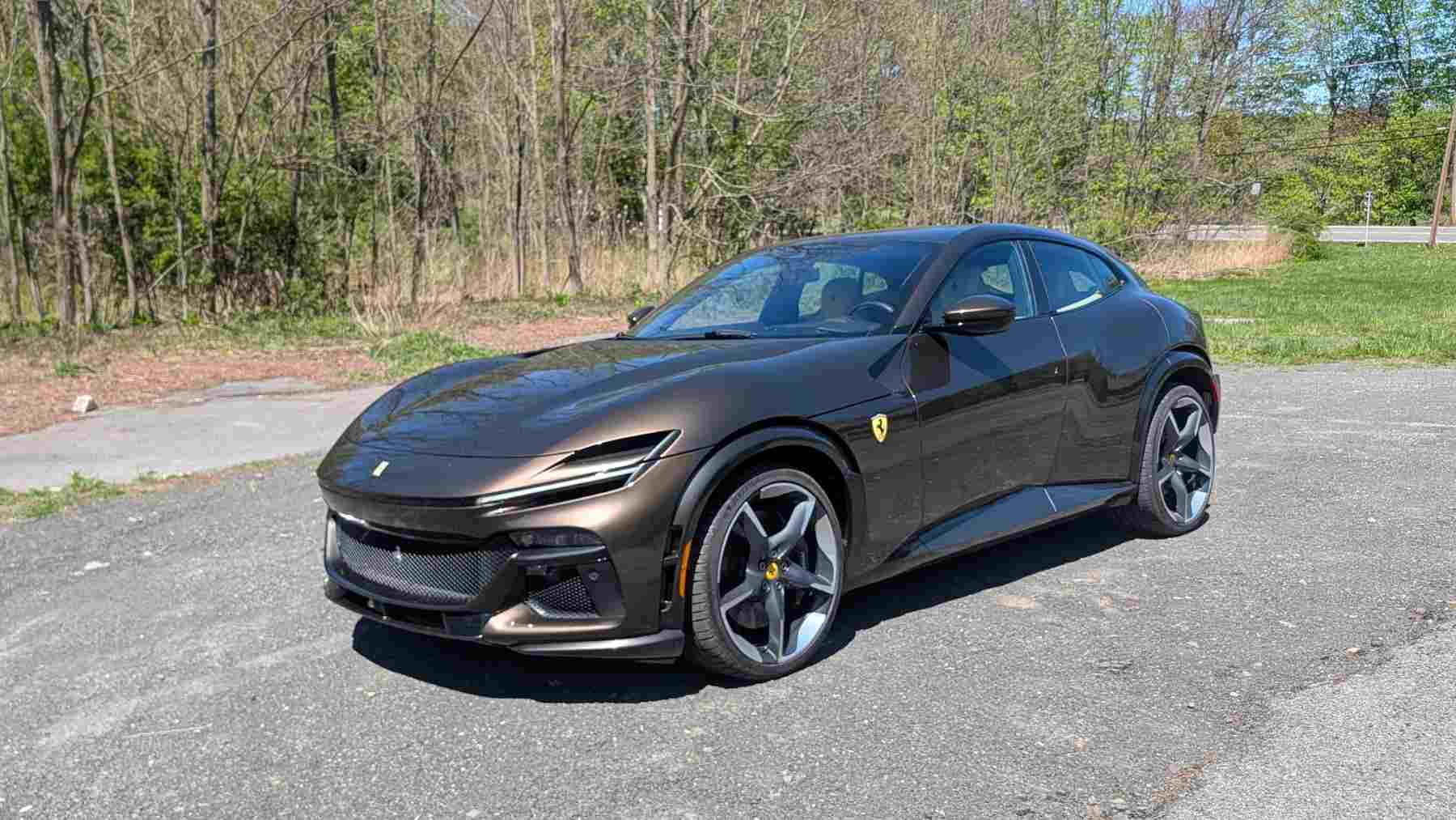Front 3/4 view of a a Ferrari Purosangue on a back road