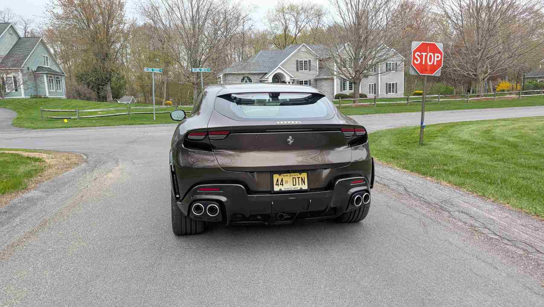 Rear shot of a a Ferrari Purosangue at a stop sign
