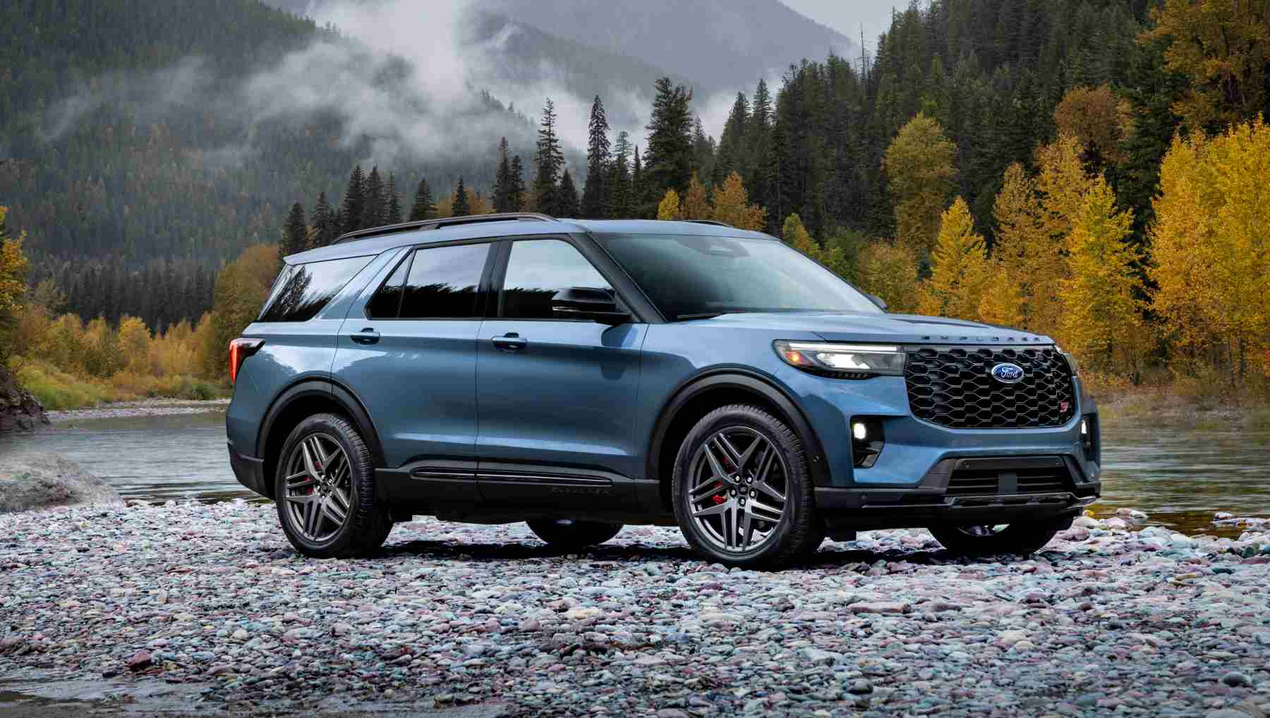 A blue 2025 Ford Explorer near a river