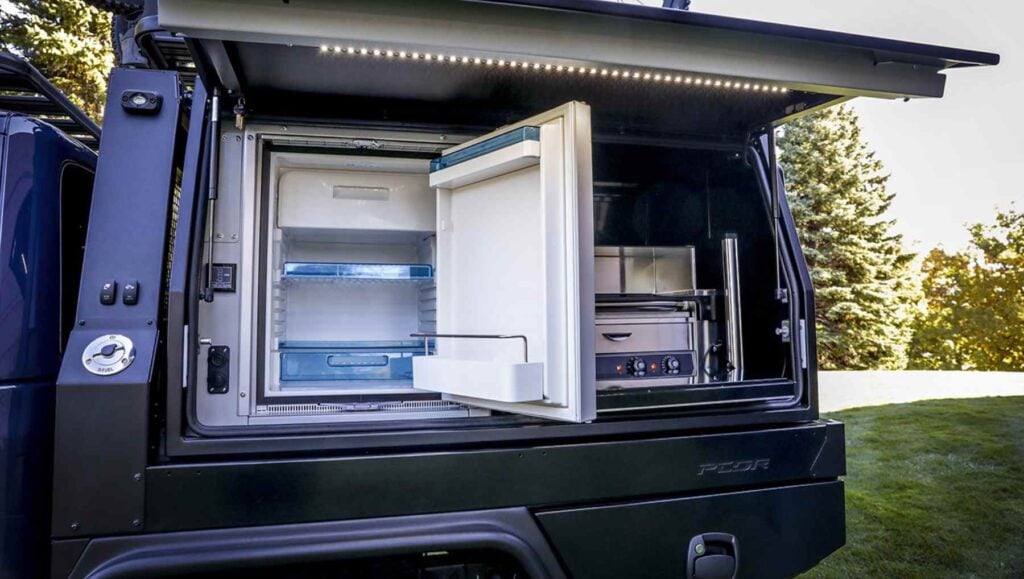 On the driver’s-side of the PCOR storage system of the Jeep Top Dog Concept, a battery-powered refrigerator and electric hot-dog roller grill stand ready to refuel riders for the next section of challenging trails.