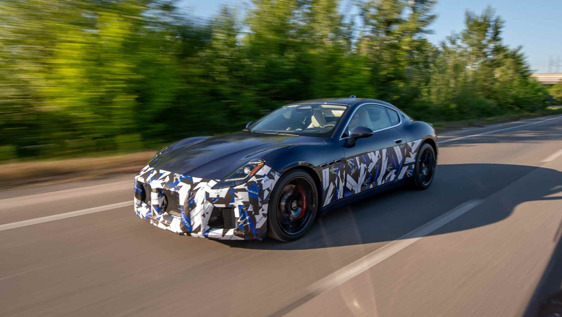 A blurry photo of a prototype Maserati GranTurismo