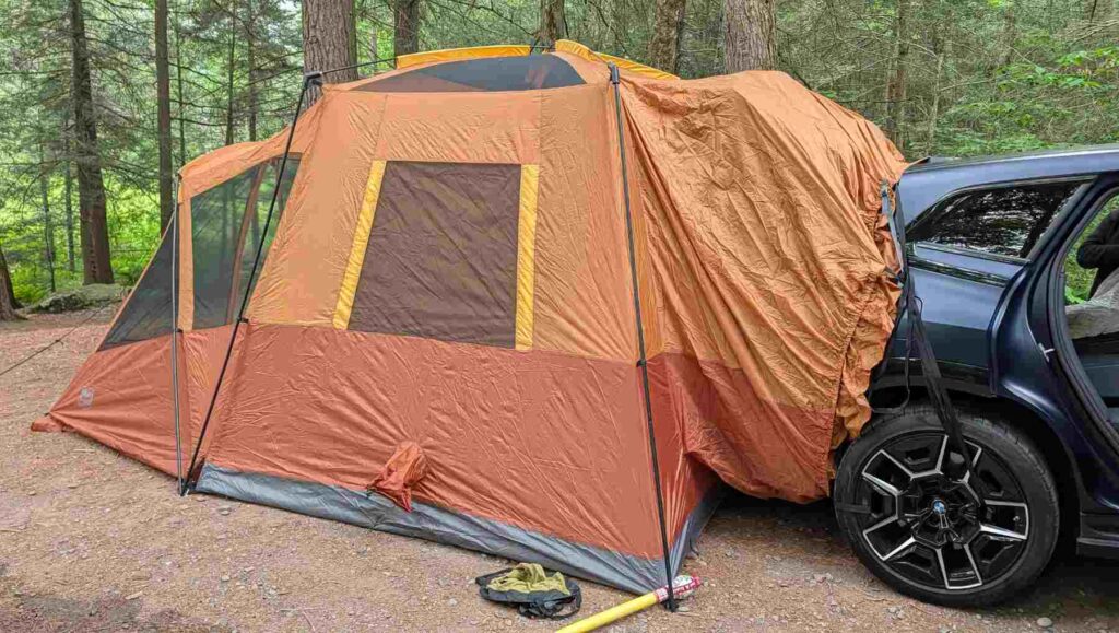 An orange Car camping tent on the back of an SUV