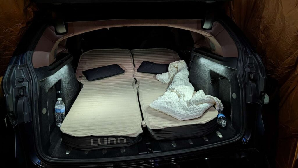 A Luno car camping mattress set up in a BMW XM