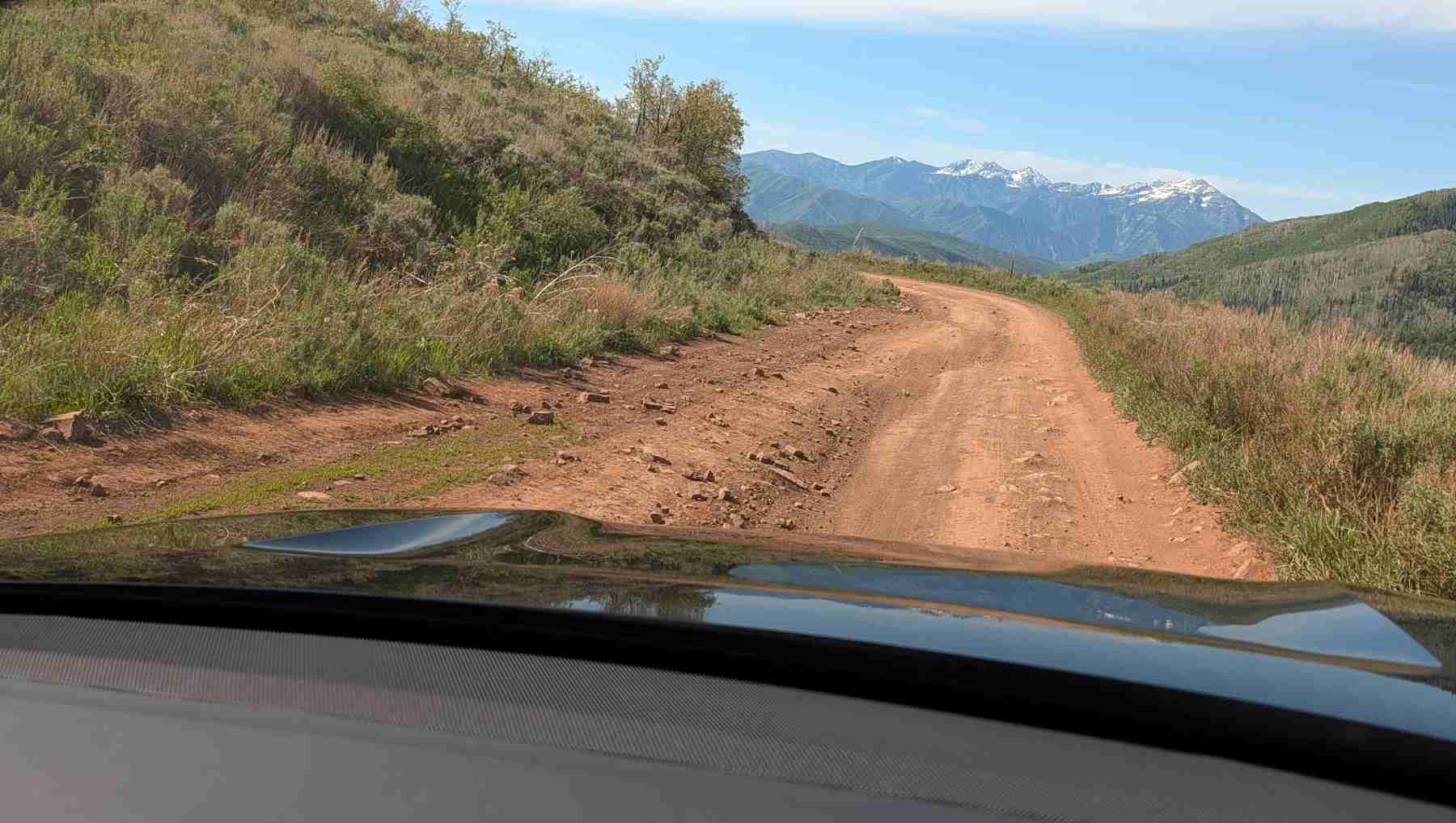 First person view from a Rivian R2 on a mountain trail