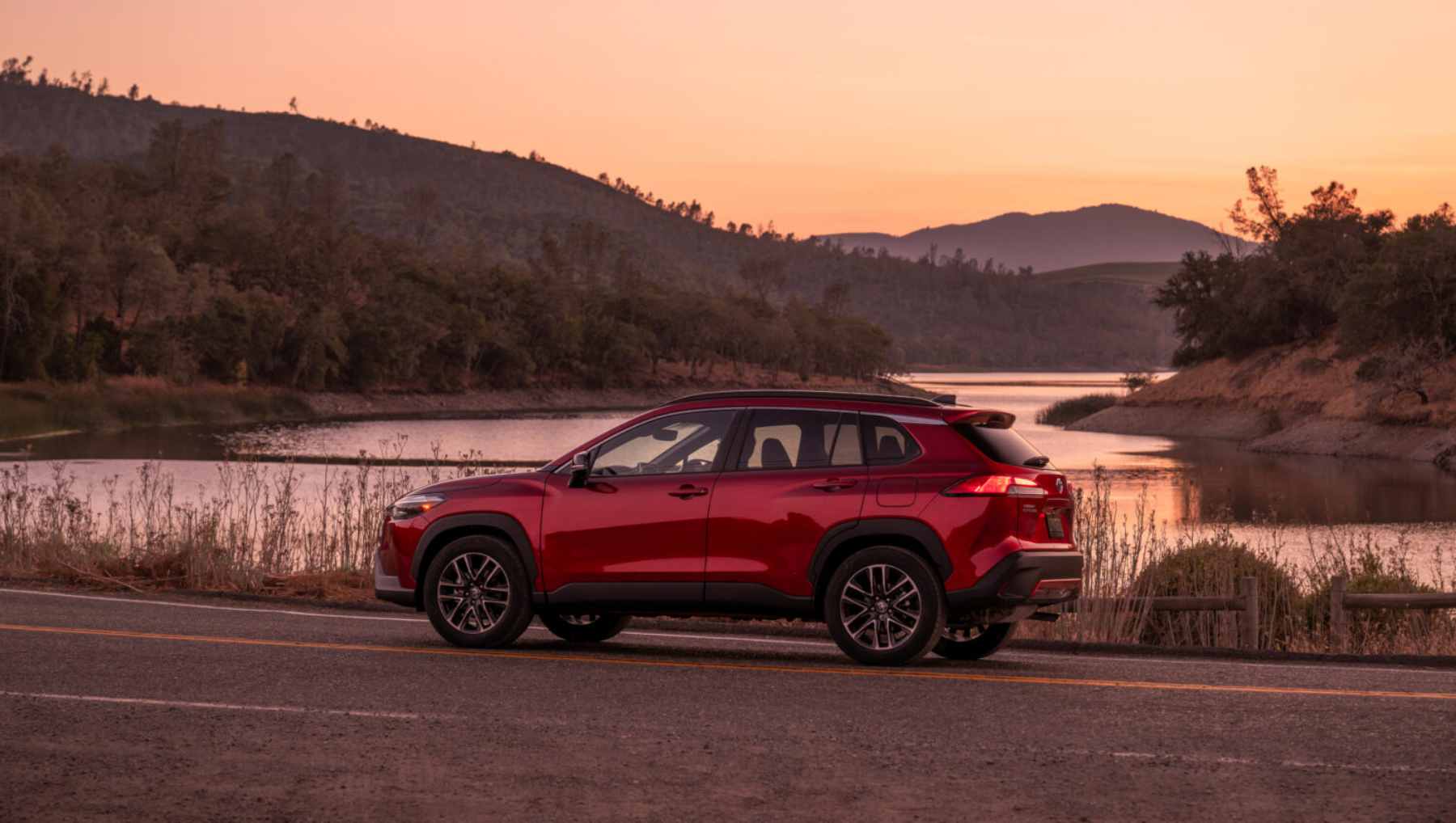 Side view of a red 2026 Toyota Corolla Cross