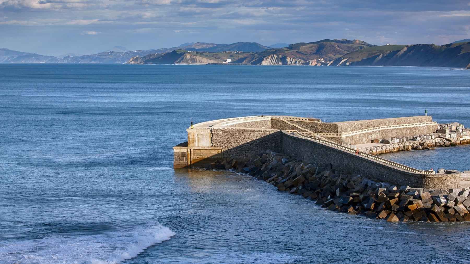 While America’s flagship wave power site sits wired and empty off Oregon, a breakwater in a Spanish town of 5,000 turned 15 this month with more operating hours than anything in wave energy, and an Australian turbine just signed on to join it