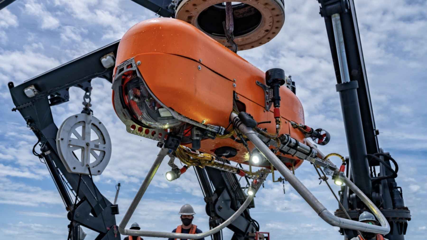A neon submarine drone just spent a month hopping across the deep Pacific floor nearly four miles down, dropping onto the mud to grab a core, then skipping to the next spot to map a seabed almost nobody has ever seen