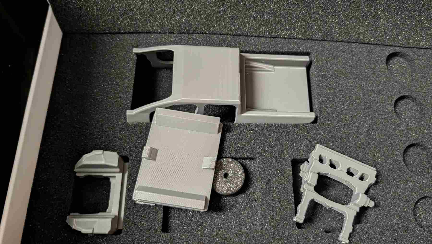 A yet to be assembled grey 3D printed model of a Ford Fathom