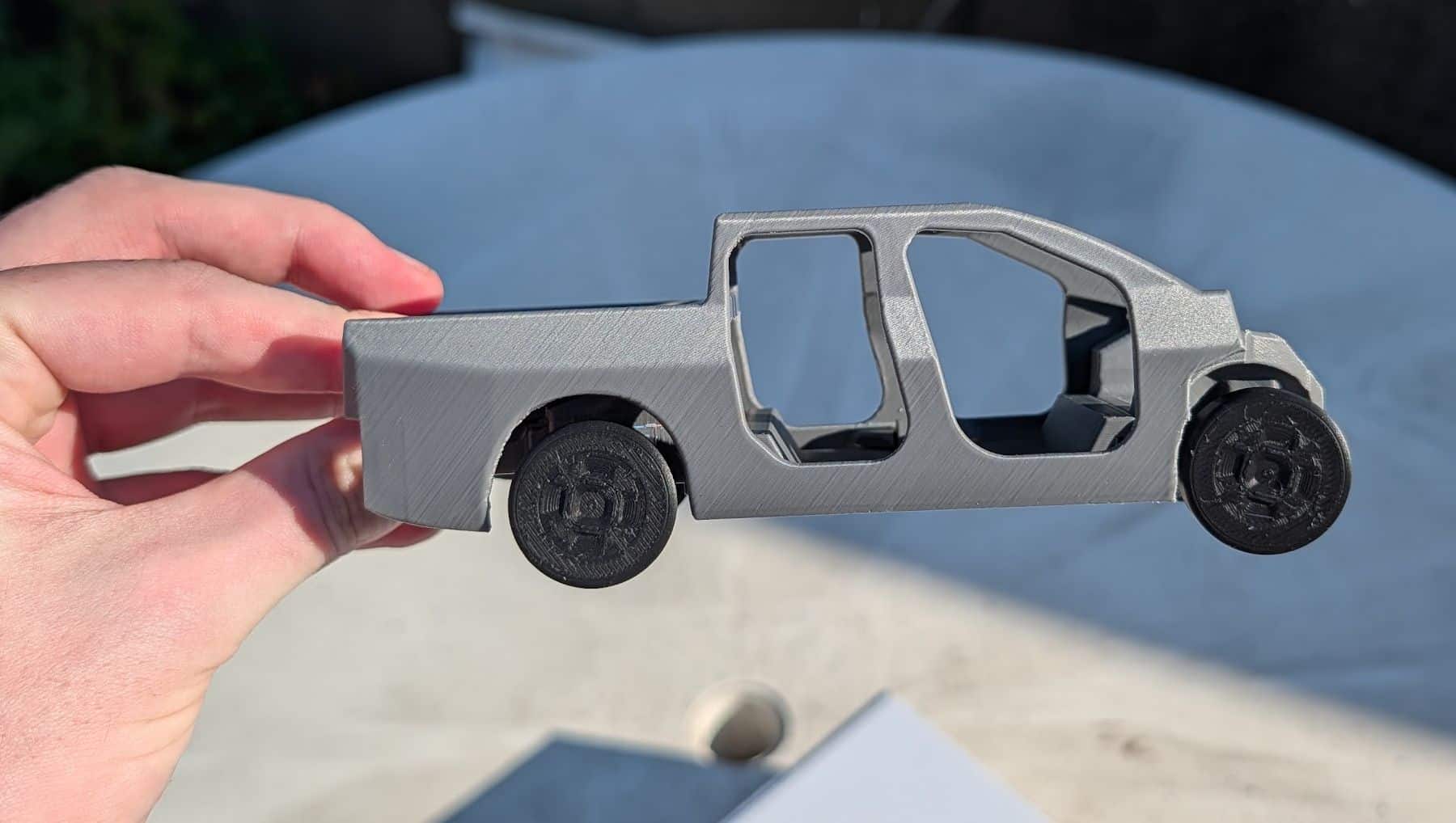 Side view of a fully assembled grey 3D printed model of a Ford Fathom