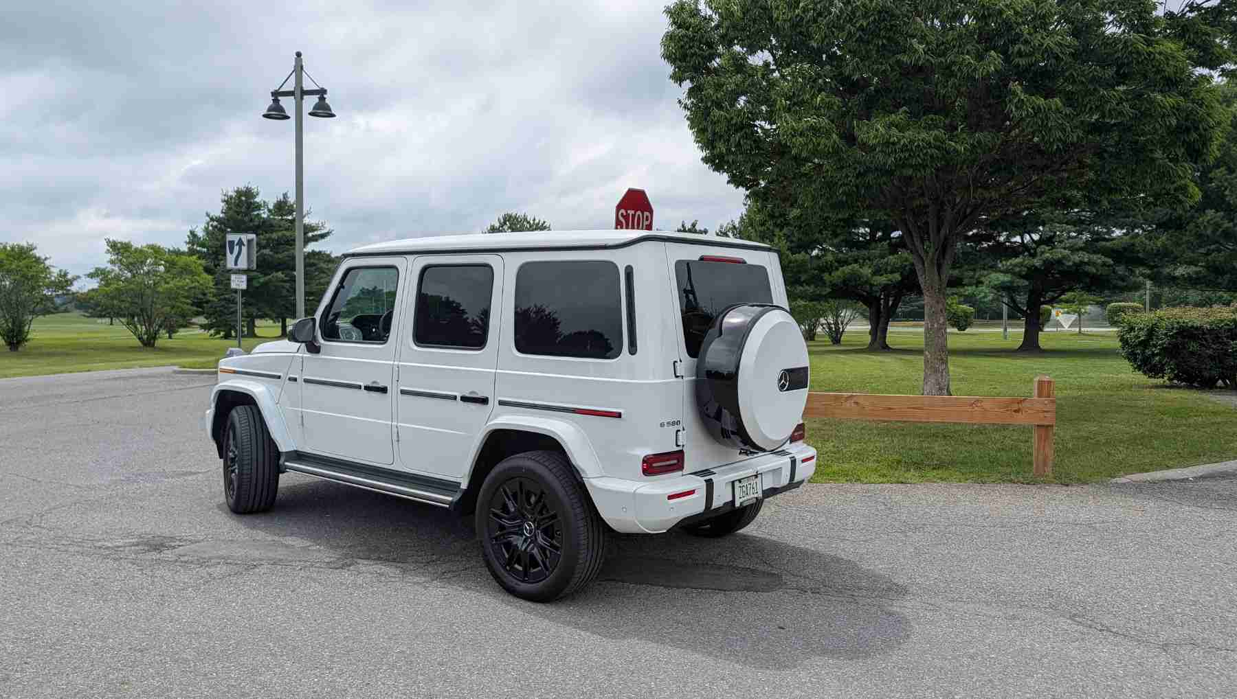 A rear 3/4 view of a white electric G-Wagen