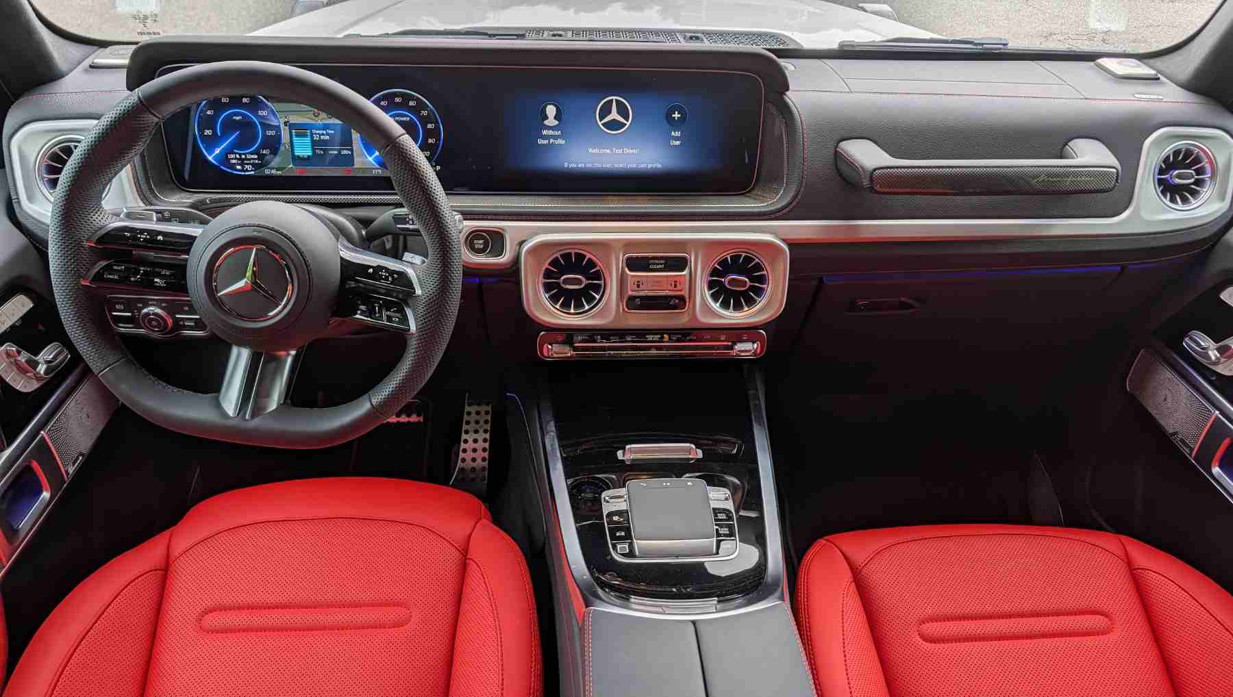 A dashboard view of a G-Wagen with a red interior