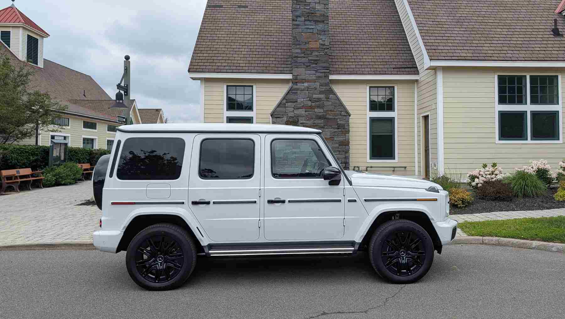 A side view of a a white electric G-Wagen