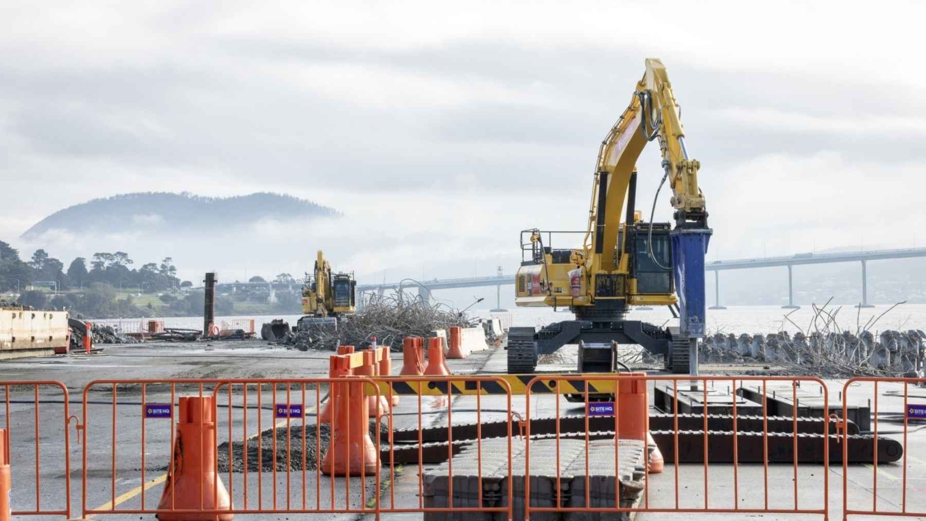 Australia is pulling 12,900 tonnes of concrete and steel out of the River Derwent with a 280-tonne crawler crane and barges underneath to catch what falls, and the ship it is doing it for still sails 419 miles to refuel