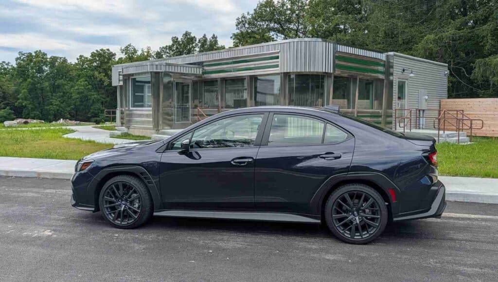2026 Subaru WRX side view in front of a diner