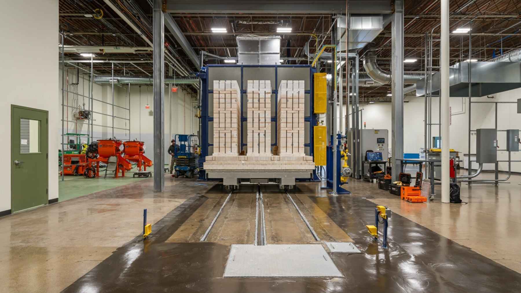 A battery of ceramic bricks runs the current straight through the brick itself, no heating wire to burn out, and hands back heat at up to 3,275 degrees — more than the 2,642 a cement kiln needs — and one of the biggest cement makers on Earth just signed up for the first two