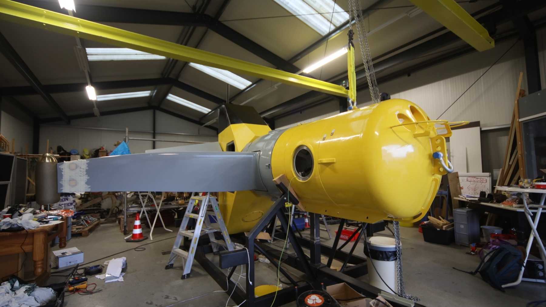 A 164-foot concrete rotor turning in the tide makes no electricity at all. A federal lab opened its hub and found a bearing and nothing else, because the only two generators on it are bolted to the blade tips, and its Dutch builder now wants one in the Gulf Stream off Florida