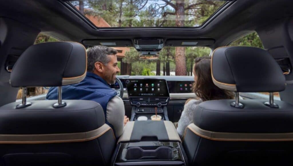 Man and woman in a car with GM's new infotainment system