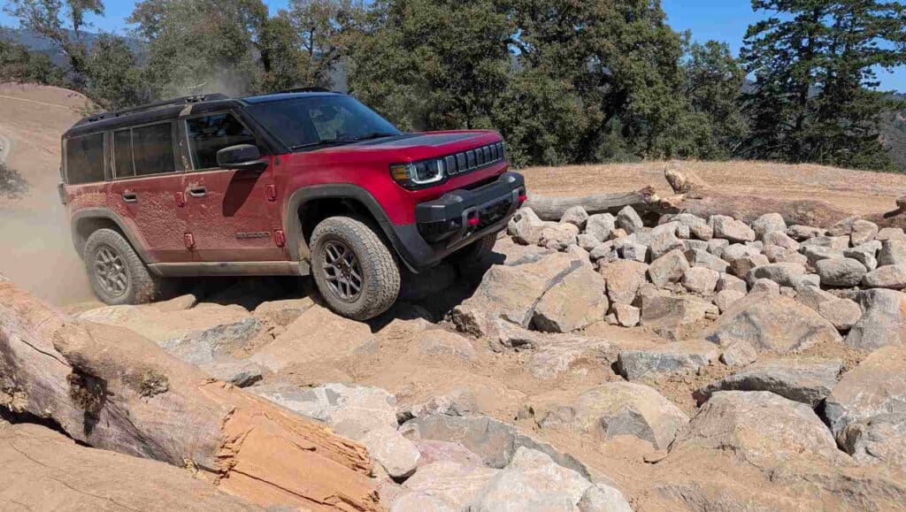 A front view of a red 2026 Jeep Recon on rough terrain