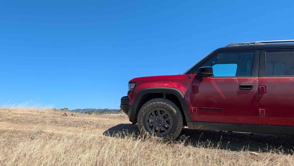 The front of a red 2026 Jeep Recon with the sky in the background