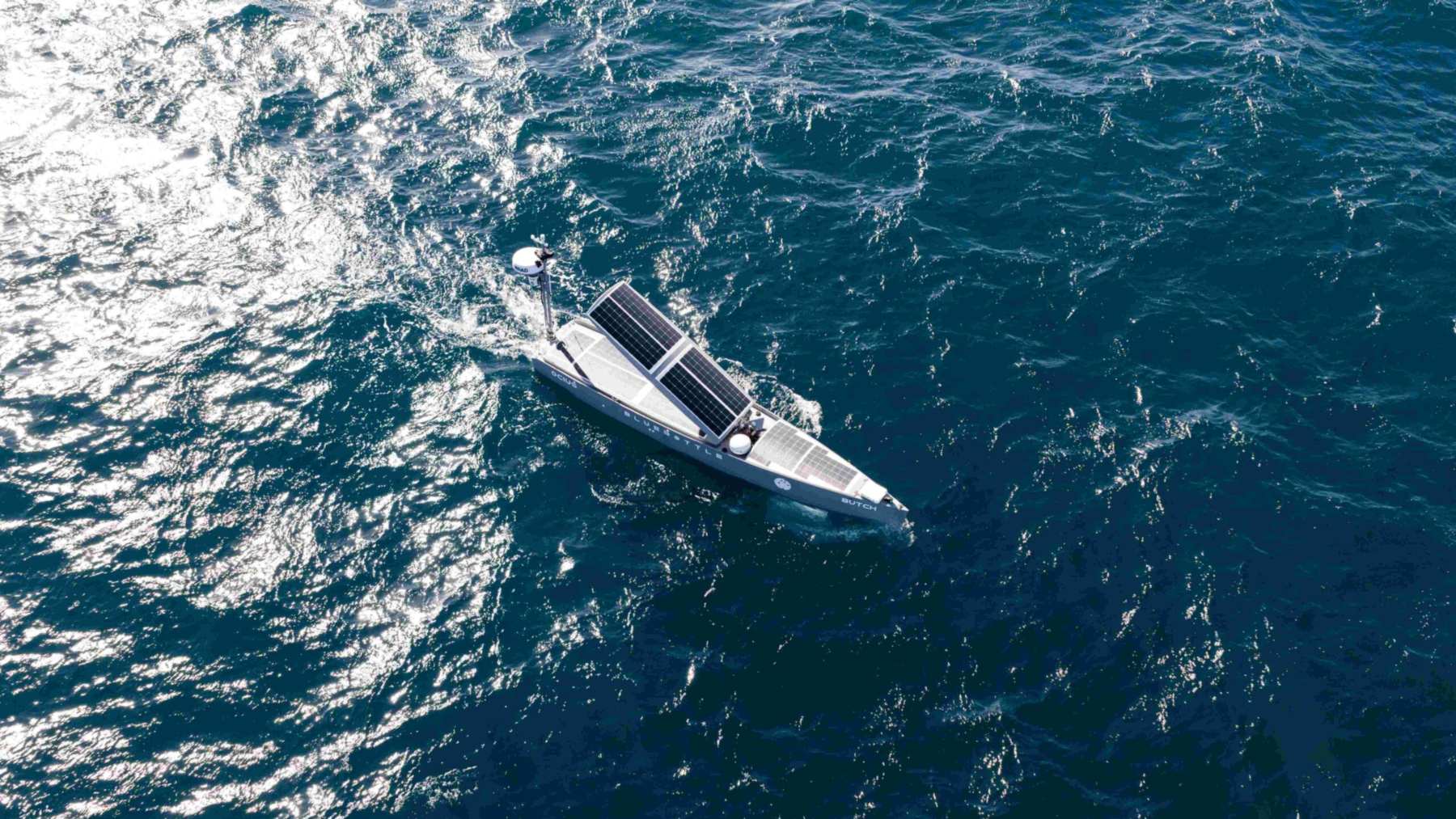 A 24-foot Australian drone boat that runs on sun, wind and waves just got a diesel generator bolted in for dark winters, and two of them spent a month towing American listening arrays 10 miles off Southern California, a 330-pound winch in each keel lowering a cable strung with hydrophones
