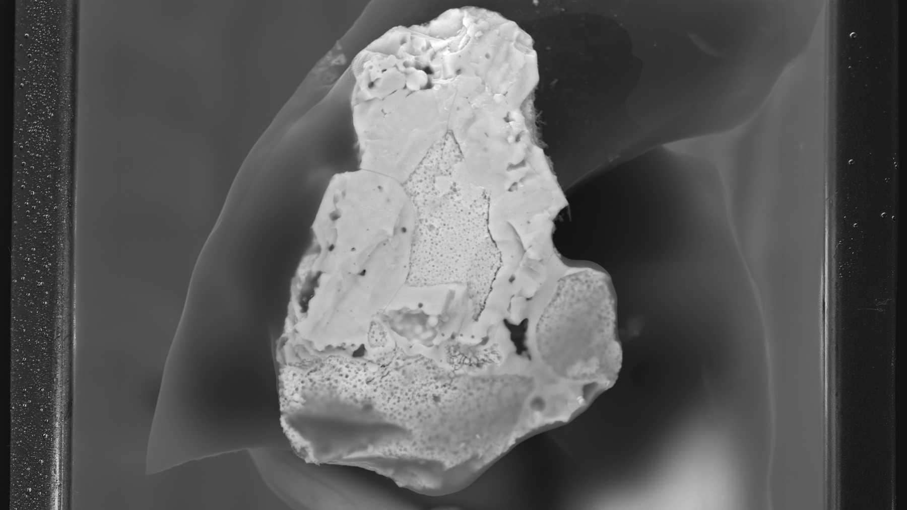 Six specks of Chernobyl reactor fuel no wider than 0.002 inches spent 40 years in the soil with their crystal structure still largely intact, and German scientists found it by rotating each one through 2,000 angles in an X-ray beam wider than the specks themselves