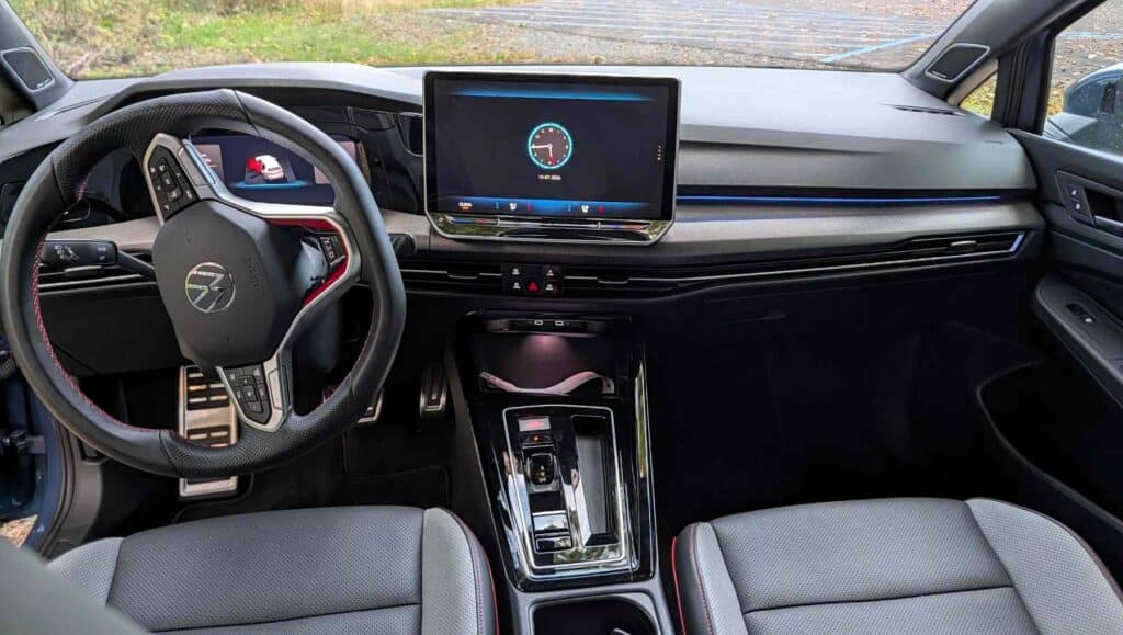A dash view of a A side view of a blue 2026 Volkswagen Golf GTI