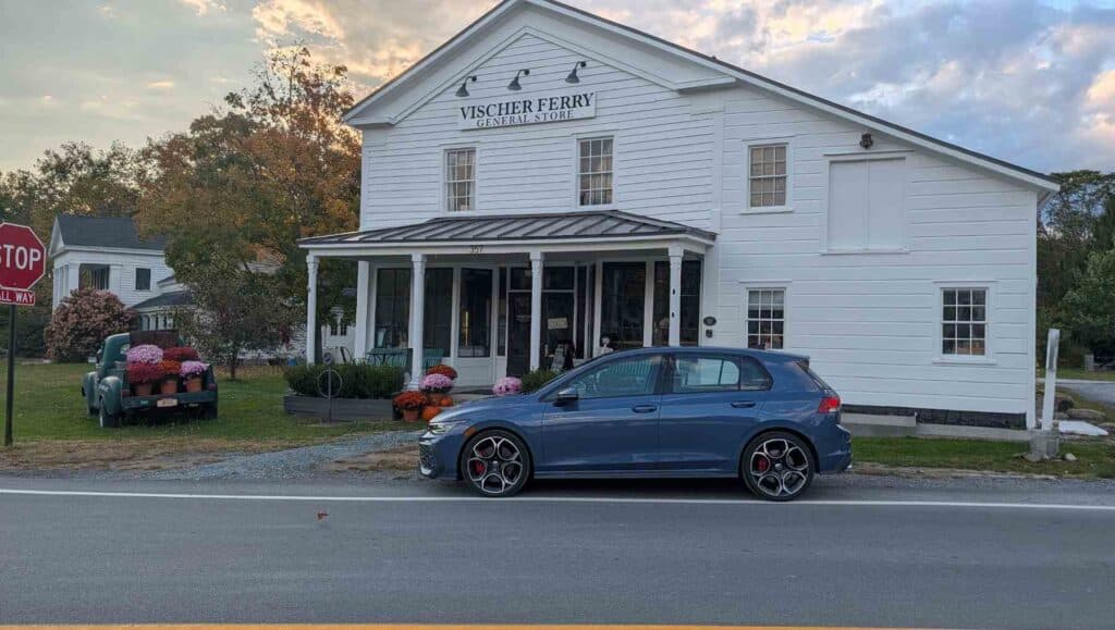 A side view of a blue 2026 Volkswagen Golf GTI