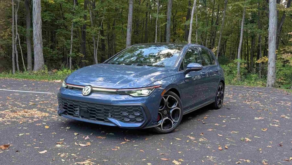 A front 3/4 view of a A side view of a blue 2026 Volkswagen Golf GTI