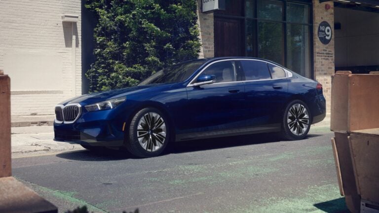 2026 BMW 5 Series in blue, front three-quarter view