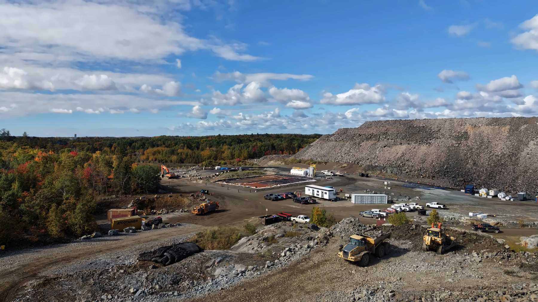 A flooded nickel and copper mine outside Sudbury sat under water for 25 years with every building on top torn down, and a small Ontario company just approved digging a new ramp into it, pumping it dry and putting the old shaft back to work to haul out 2,400 tons of rock a day for 12 years