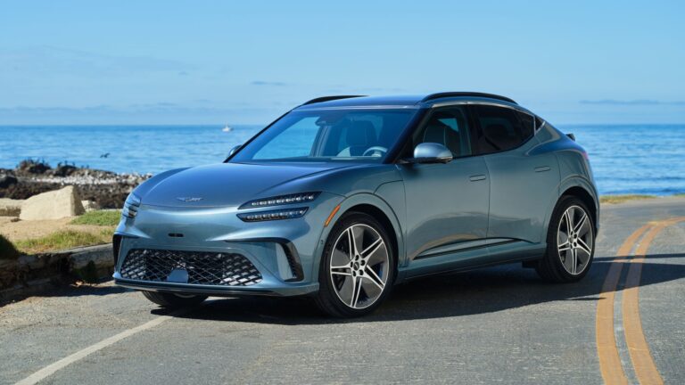2026 Genesis GV60 in blue-gray, front three-quarter view
