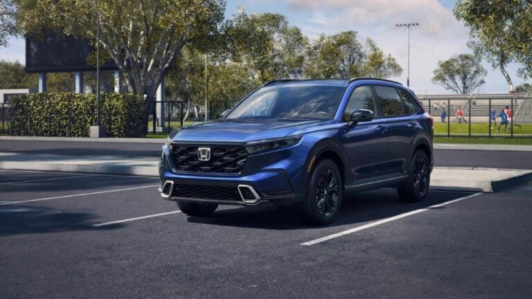 2026 Honda CR-V Hybrid, Sport Touring front three-quarter view in blue
