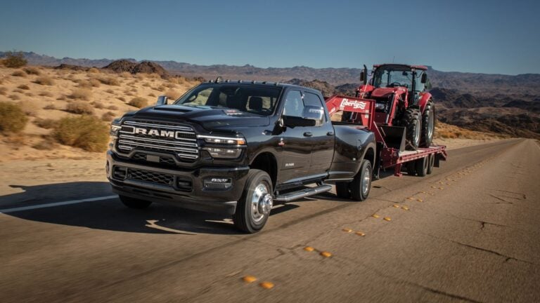 2025 Ram 3500 Heavy Duty Laramie in black towing, front three-quarter view